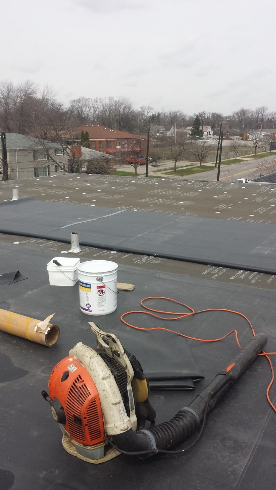 Black EPDM membrane installation on a Detroit commercial flat roof