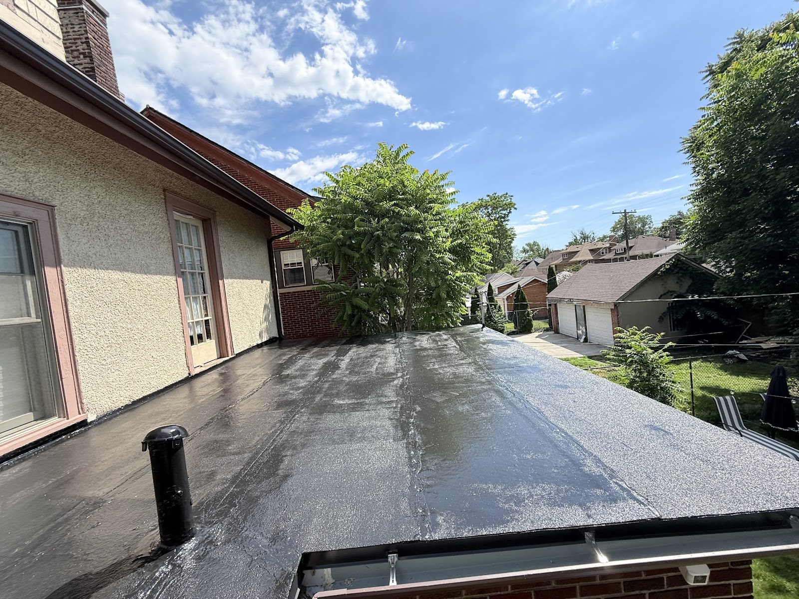 Silicone-coated low-slope residential roof in Detroit's Boston-Edison neighborhood