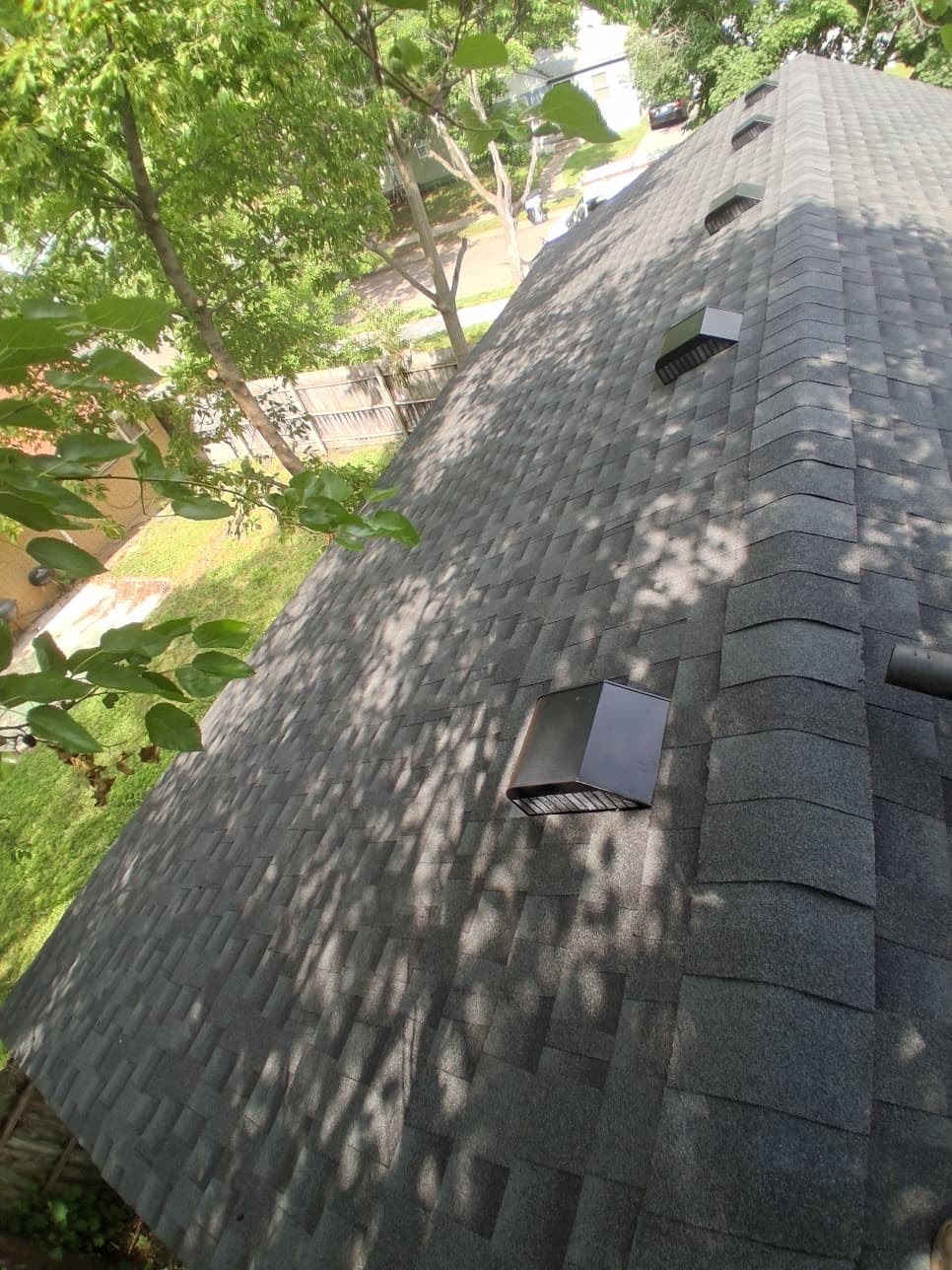 New asphalt shingles, ridge caps, and roof vents on a Detroit ranch home